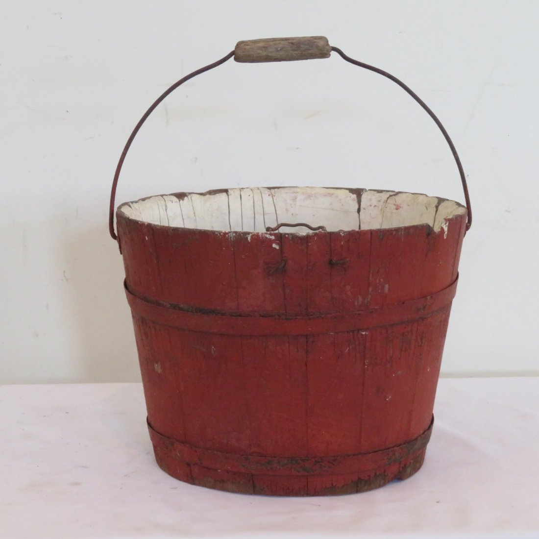 Wood New England sap bucket in old red paint: Wood New England sap bucket in old red paint with wire bale and wood handle, painted white interior, 9" x 11.5"