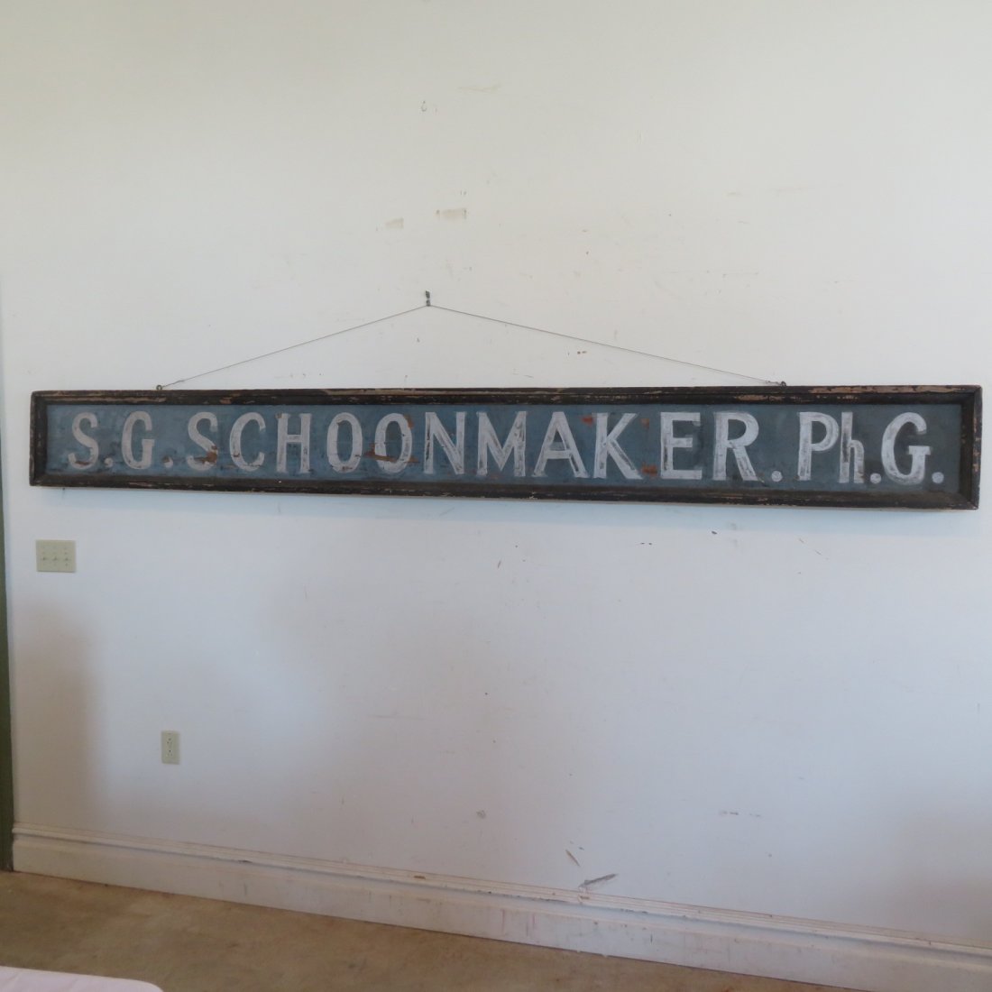 Wood trade sign for S.G. Schoonmaker: Old wood trade sign for S.G. Schoonmaker, PH G, Schoonmaker ran a drug store in Speculator, NY. Sign has molding around the entire perimeter. All original paint and wear, 13" x 118"