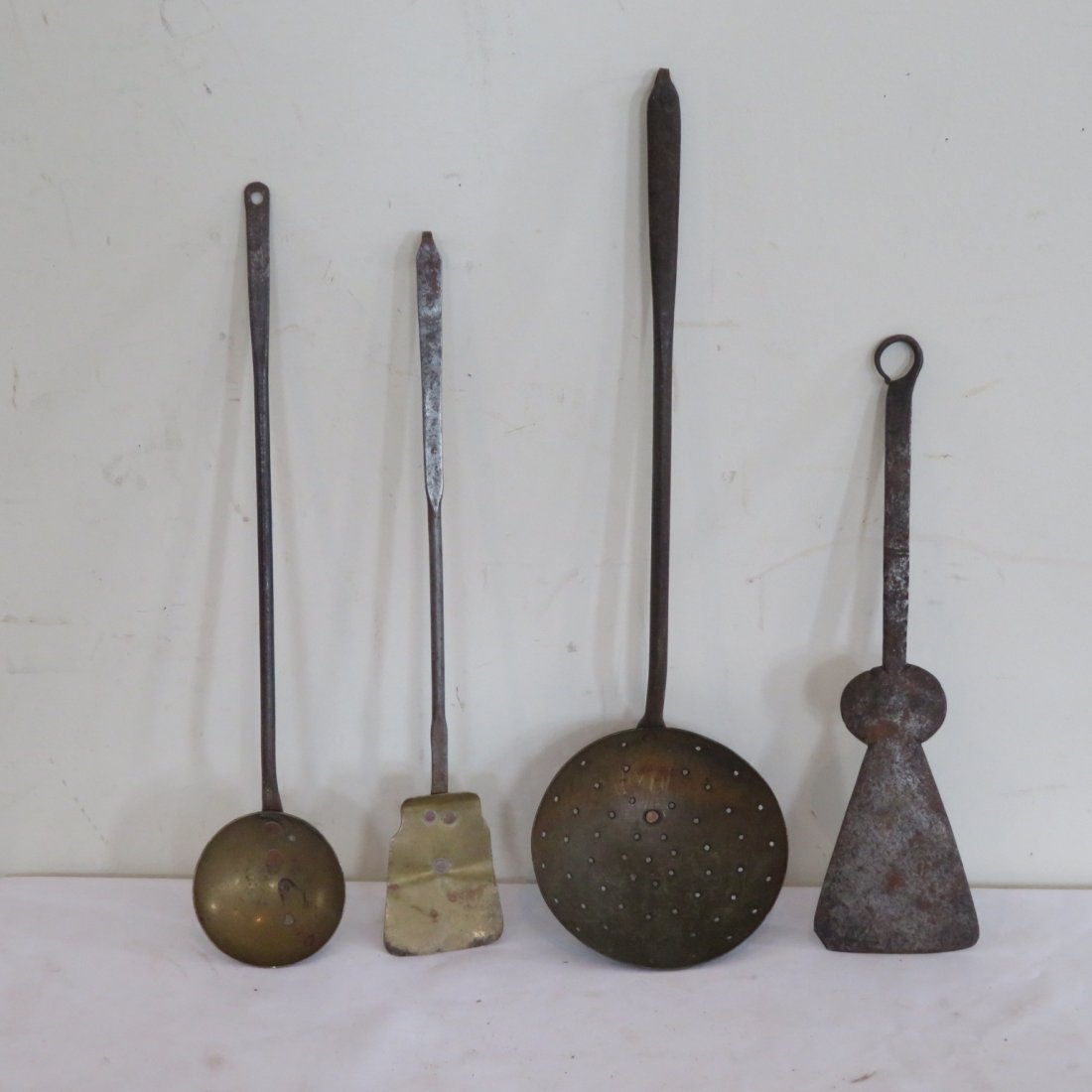 Group of 4 fireplace cooking utensils: Group of 4 fireplace cooking utensils, ladle, 2 spatulas, longest item is skimmer and it is 18" long, iron and brass construction
