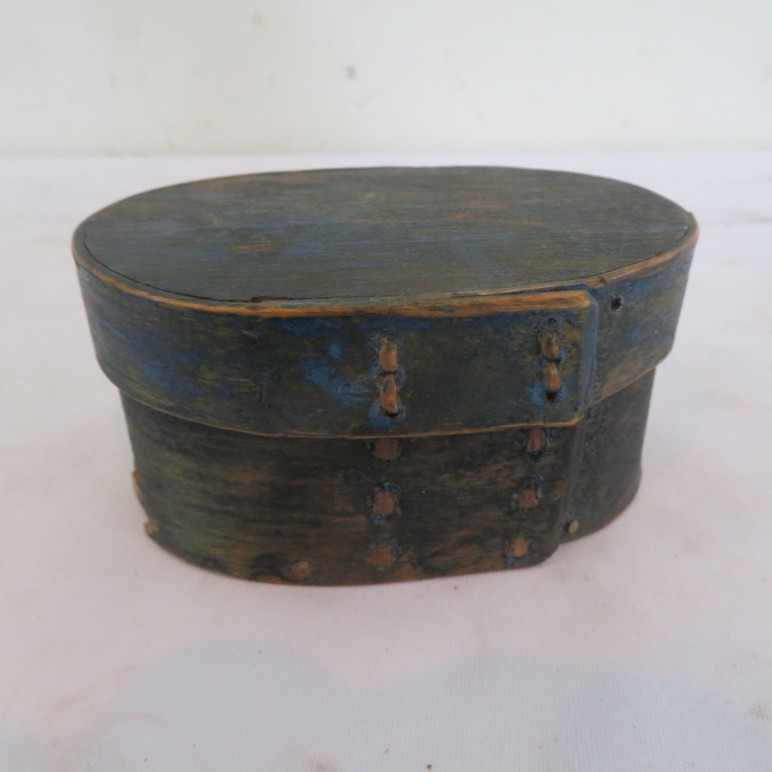 Early small oval pantry box, worn blue paint: Early small oval pantry box, braided fingers, worn blue paint, 2.25" x 4.5" x 3"