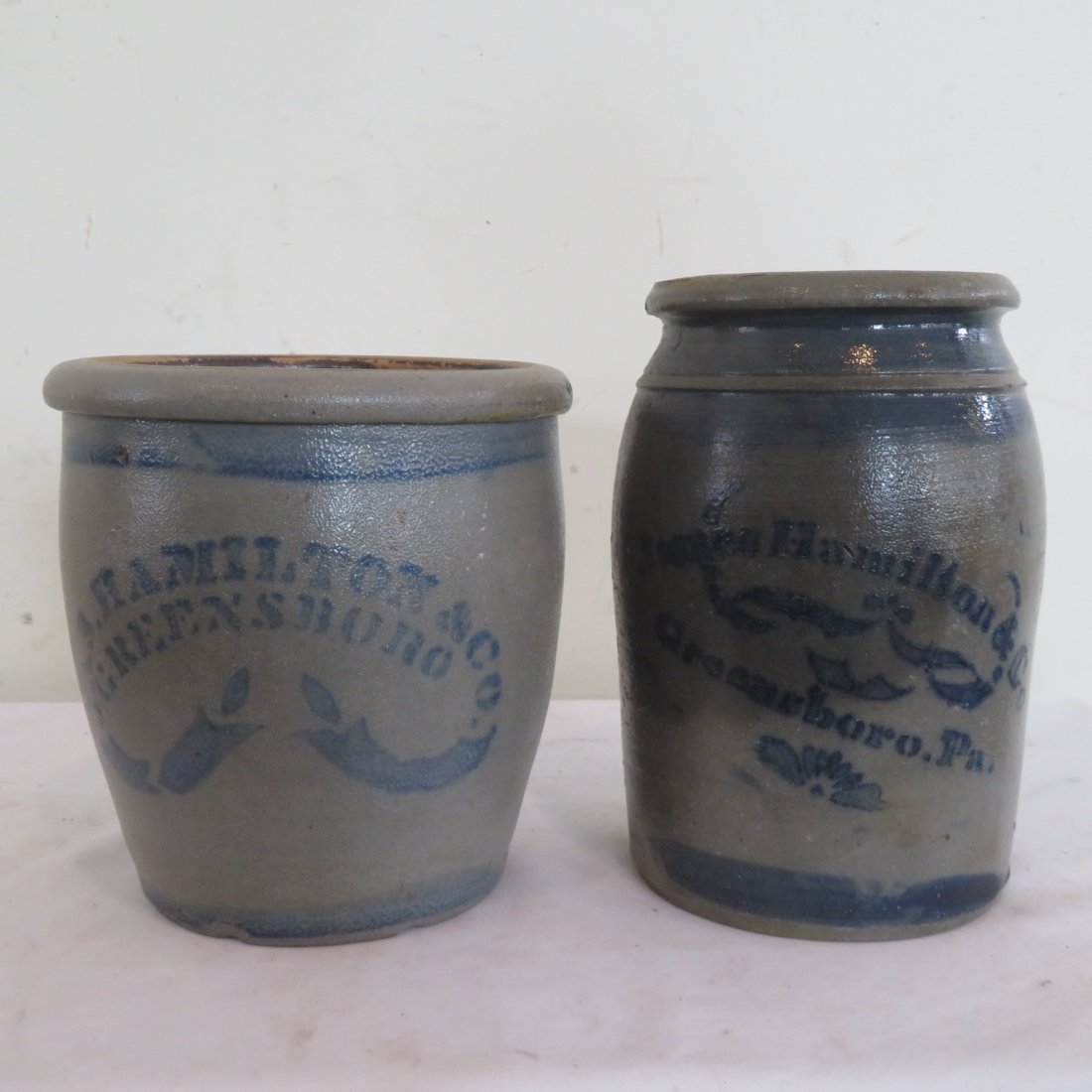 2 stoneware James Hamilton, cream pot & 1 gal jar: 2 stoneware, signed James Hamilton, Greensboro, PA, cream pot is 8"H x 7.5"W & 1 gal jar is 9.5"H x 6"W.