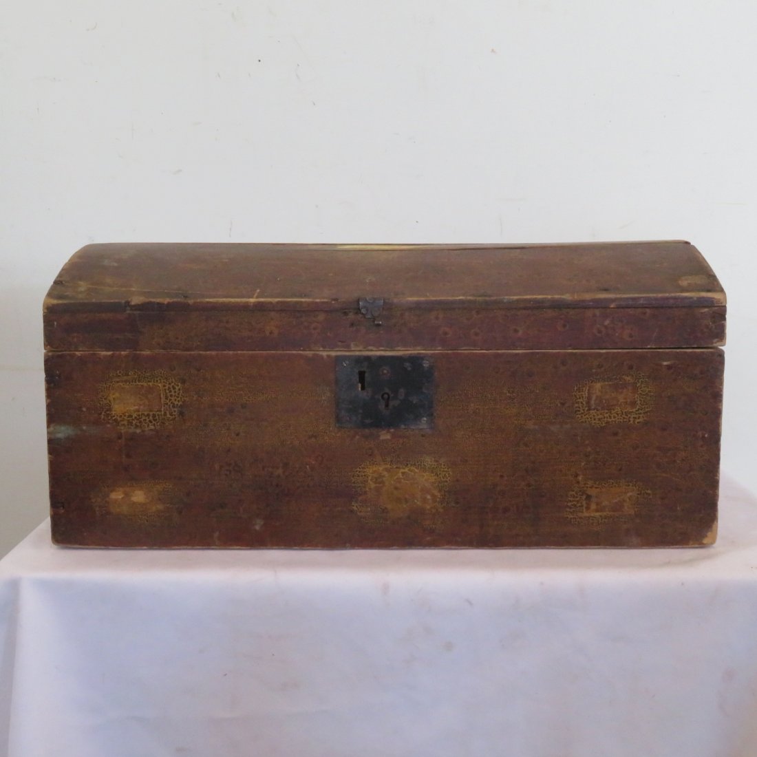 Pine paint decorated dome top box: Pine paint decorated dome top box, paint resembles bird's eye maple, square nail construction, interior evidence of being wallpaper lined, 11" x 24" x 12"