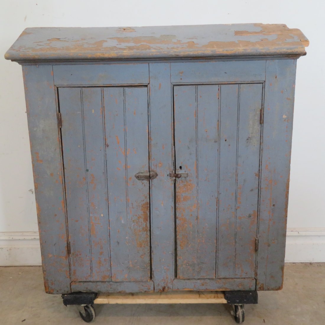 Pine under the eaves wall cupboard: Pine under the eaves wall cupboard in old blue/grey paint with wainscot doors, probably used for tools and paint in a garage, square nail construction, 39" x 39" x 8"