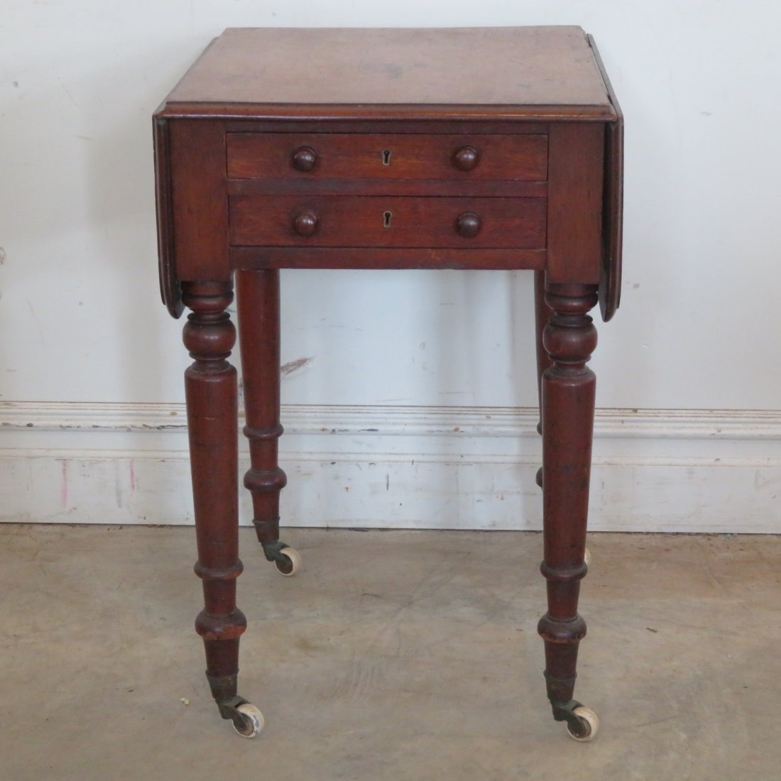 Federal mahogany 2 drawer stand with drop leaves: Federal mahogany 2 dovetailed drawer stand table with drop leaves, 2 faux drawers on back side, brass casters with porcelain wheels, 8.5" drop leaves, 28.5" x 18.5" x 21"