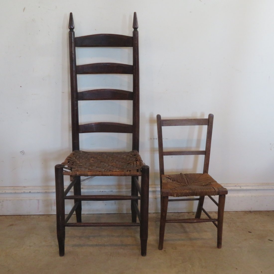2 ladder back chairs: 2 ladder back chairs, large chair has a splint seat that is rough 46"H, small chair has a rush seat that is rough 24.5"H, both are in original finish