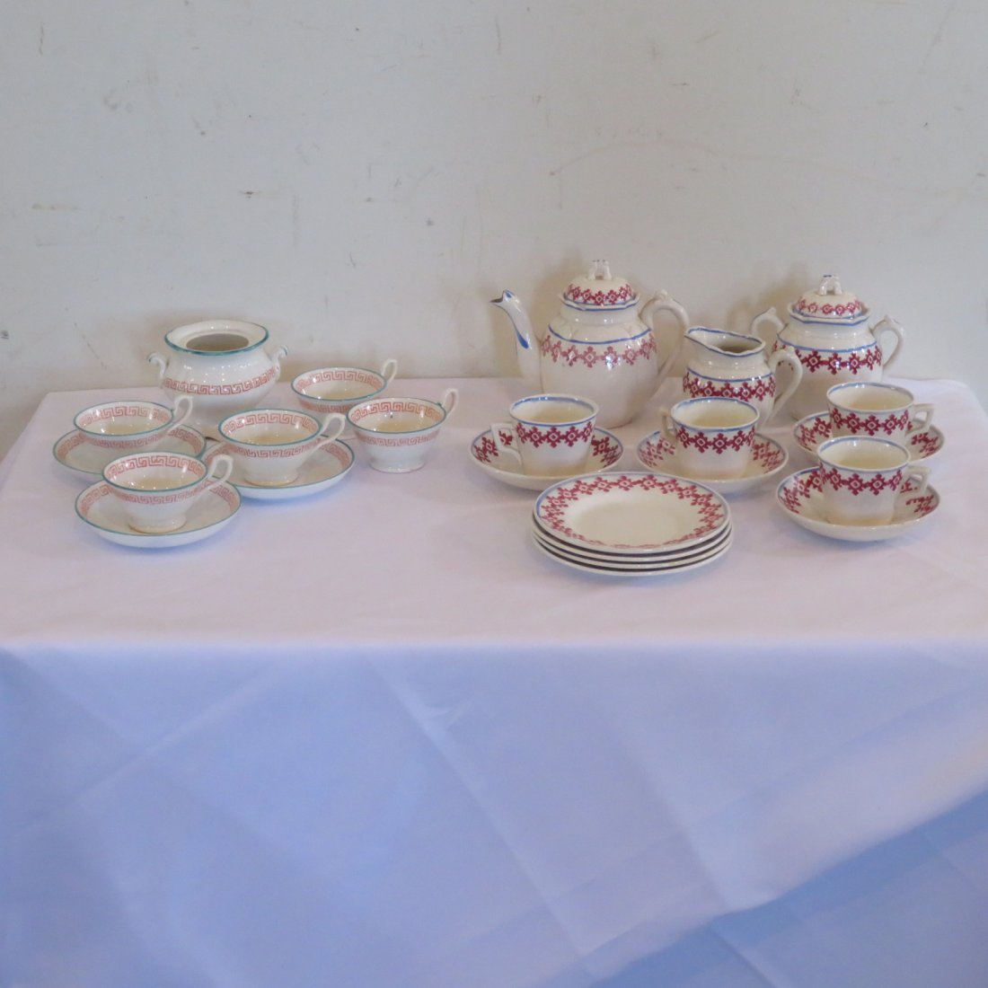 2 child tea sets: Staffordshire set is 15 pieces, includes tea pot, creamer, sugar, 4 cups, saucers, and plates - marked Staffordshire, England, second group is unmarked and is 9 pieces, includes sugar bowl (no lid), 5