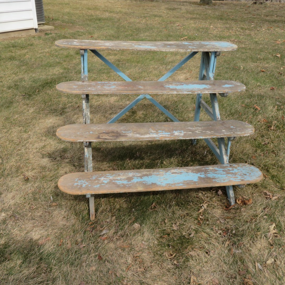 Pine 4 shelf canted plant stand: Pine 4 shelf canted plant stand with traces of blue paint, round nail construction, 44" w. x 30" t. x 32" d. at bottom shelf