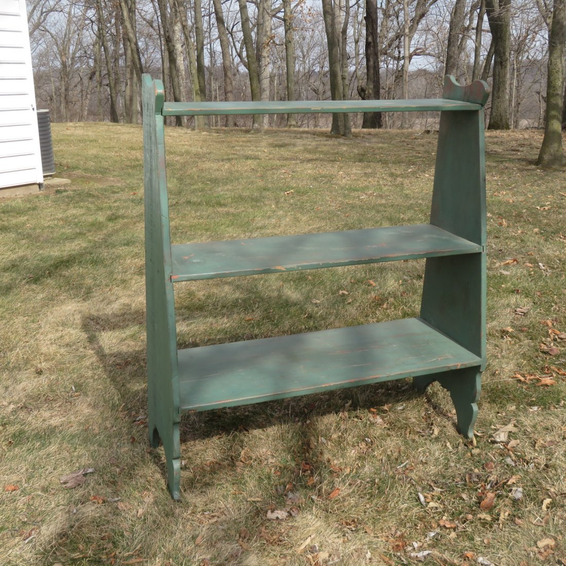 Canted 3 shelf painted pine bucket bench: Canted 3 shelf painted pine bucket bench, 54"t. x 47" w. x 18" d. at bottom shelf. Square nail construction, later green paint.