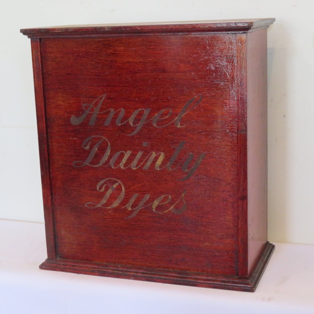 Angel Dainty Dye's cabinet: Mahogany Angel Dainty Dye cabinet with rear door with many cubbies for packets of dyes. 18" tall x 16" wide by 8 1/2" deep