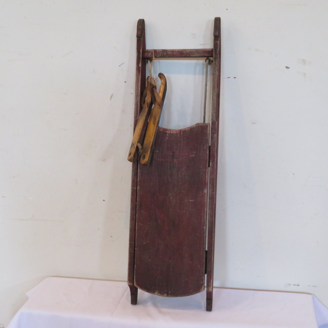 Wood sled in old red paint and wood ice skates (1 of 6)