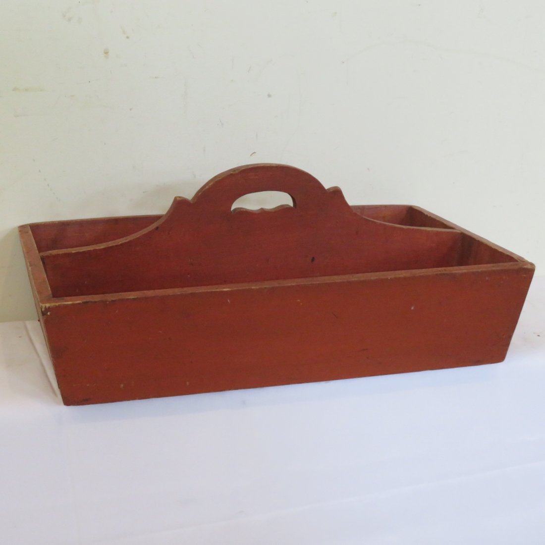 Wooden utensil carrier in old red paint: Wooden utensil carrier in old red paint with decorative handle, 9.5"H x 21"L x 13"D