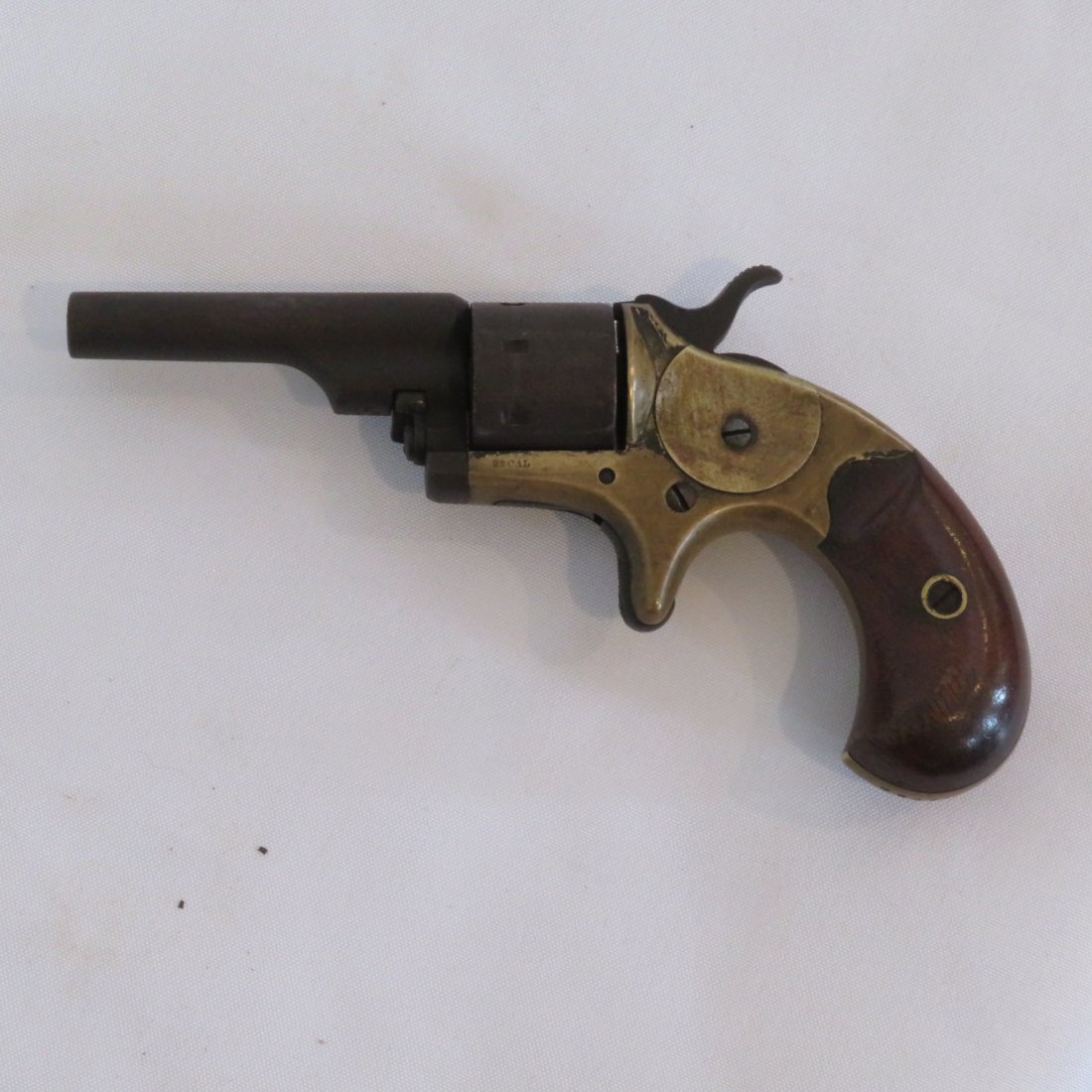 Colt .22 cal. 1870's pocket revolver: Colt, Hartford, CT ca. 1870's brass frame 7 shot .22 cal. pocket revolver with wood grips, spur trigger, 2 1/2" barrel, serial # 72095