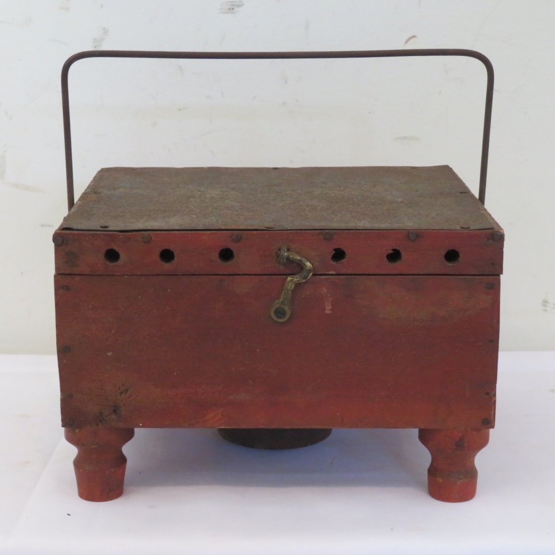 Wood and tin Shaker footwarmer: Wood and tin footwarmer attributed to the Shakers, unusual tin interior with a whale oil burner, in original red paint and has heavy wire bail handle, 5"t. x 7" x 7 3/4"