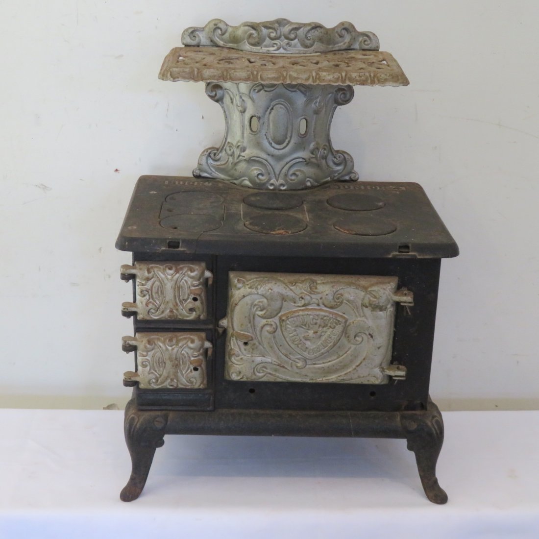 Cast iron and tin Buck's Junior 4 wood cookstove: Cast iron and tin Buck's Junior 4 wood cookstove, 23' t. x 16" x 11"