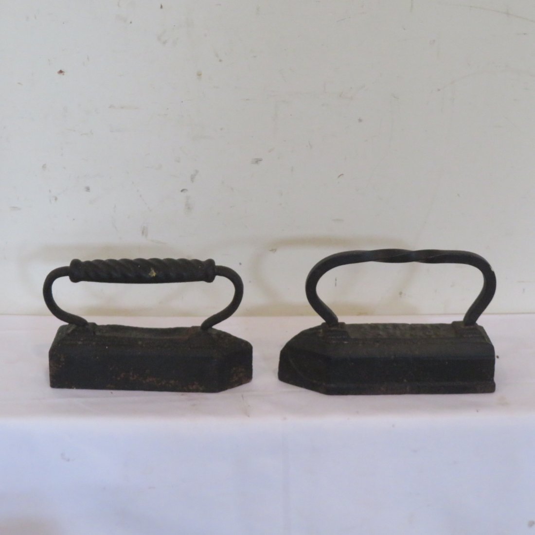 2 19th century tailor's irons: 2 19th century tailor's irons, cast iron, great doorstops! One is signed American Manufacturing, 7"H x 10"L