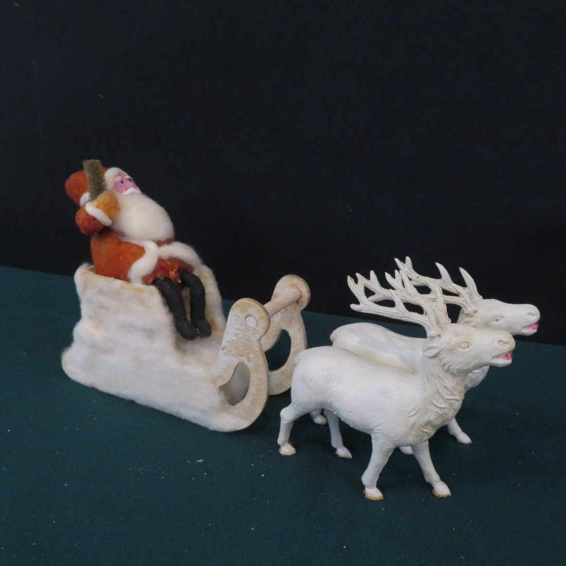 9"L Santa in sleigh with 2 reindeer: 9"L Santa in sleigh with 2 reindeer, reindeers are celluloid, sleigh is covered in cotton batting and Santa has felt suit and paper mache face, unmarked, 5"T