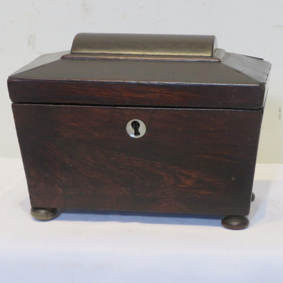 Mahogany tea caddy: Mahogany footed tea caddy with MOP inlaid escutcheon, 2 interior compartments with lids, 6" t. x 8" w. x 5"