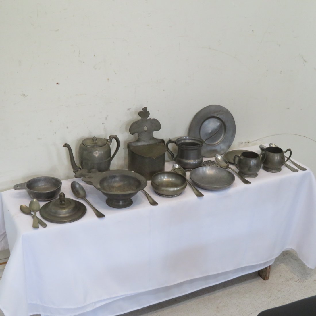 Group of 23 20th century pewter items: Group of 23 20th century pewter items includes: hanging salt 9.25"H, porringers, mug, 6 tablespoons, compote, plate, teapot, cream, and sugar