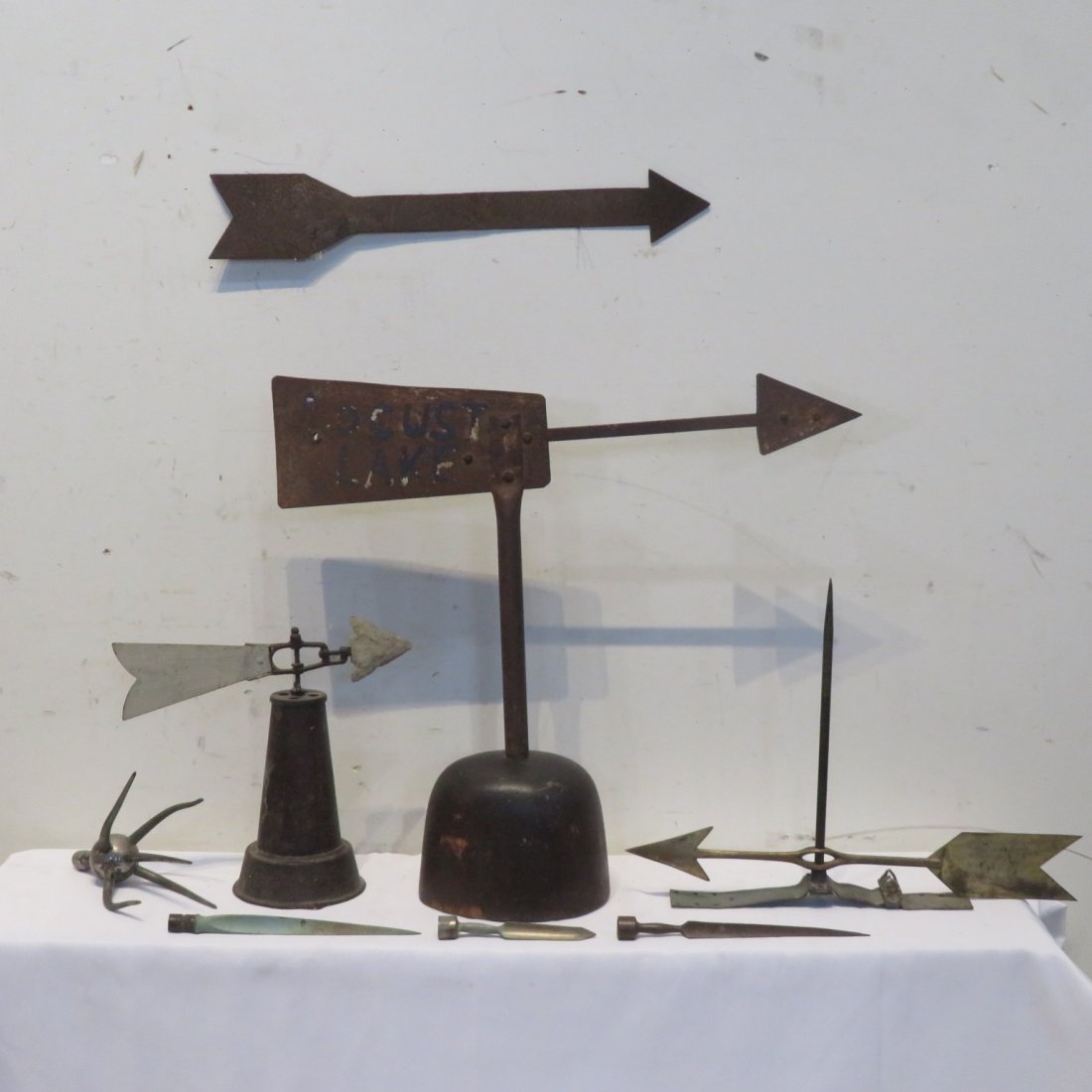 4 directionals and 4 lightning rod spikes: 4 directionals and 4 lightning rod spikes, largest directional is marked Locust Lakes 20.5"H x 23"L, one of the spikes has 5 points