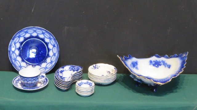 22 pcs of flow blue: 22 pcs of flow blue including: LaBelle footed helmet dish 6"T x 13"L x 10.5"W, 6 bone dishes (Devon pattern), 6 butter pats, 6 saucers, and plate with names of states with matching cup and saucer