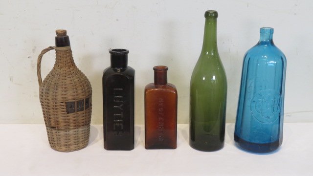 5 old bottles: 5 old bottles includes blue 11" seltzer bottle with round logo on 2 sides with the embossed letters CCOBQ, 8 1/2" amber bottle with embossed LUYTIES, 7" amber bottle with embossed NEOFERRUM on side an