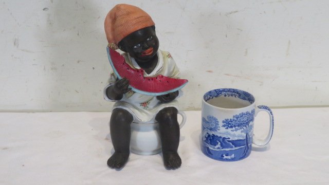 Bisque one-piece black memorabilia: Bisque one-piece black memorabilia, boy sitting on chamber pot eating watermelon, 8.5"T. Provenance the late Sally Siegrist