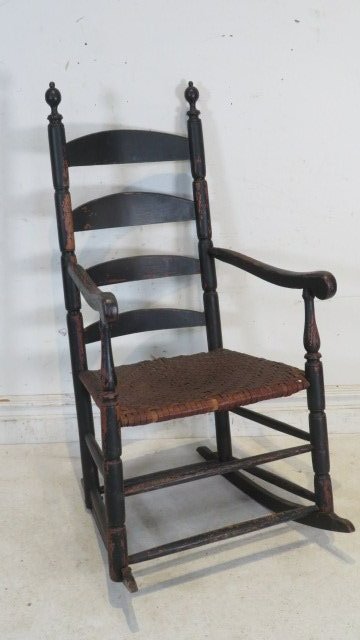 18th century ladderback armchair made into rocker: 18th century ladderback armchair with sausage turnings, finely turned finials and splint seat in an old black painted surface, 46"t. x 17" x 21" and 18" seat height