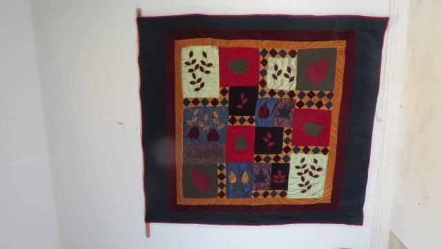 Velvet hand-stitched botanical quilt: Velvet hand-stitched botanical quilt with triple border and some silk squares, reverse side is red fabric, 85"W x 92"L