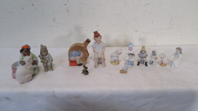 Group of 10 figures of children on chamberpots and 2 other figures (1 of 5)