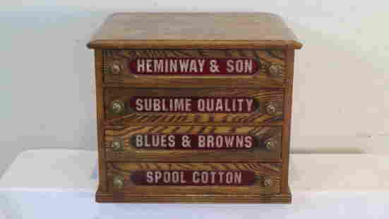 Oak 4-drawer spool cabinet with ruby colored glass in drawers: Oak 4-drawer spool cabinet with ruby colored glass in drawers and the words "HEMINWAY & SON SUBLIME QUALITY BLUES & BROWNS SPOOL COTTON", original drawer pulls, 15.5"T x 19"W x 17"D