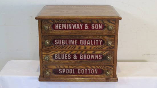 Oak 4-drawer spool cabinet with ruby colored glass in drawers: Oak 4-drawer spool cabinet with ruby colored glass in drawers and the words "HEMINWAY & SON SUBLIME QUALITY BLUES & BROWNS SPOOL COTTON", original drawer pulls, 15.5"T x 19"W x 17"D