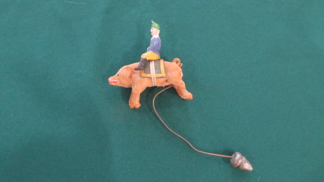 German ornament with wood soldier riding a pig and lead acorn counterweight (1 of 5)