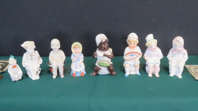 8 bisque children sitting on chamber pots (1 of 8)
