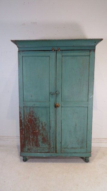 19th century poplar country wardrobe: 19th century poplar country wardrobe in blue/green painted surface over red, dovetailed case, doors are wooden pinned, on turned feet, interior is painted red, 72"T x 42"W x 19.5"D