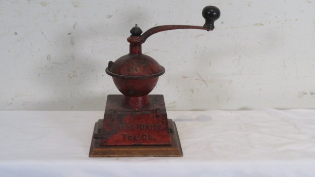 Cast iron coffee mill signed Grand Union Tea Co. in old red paint: Cast iron coffee mill signed Grand Union Tea Co. in old red paint, wooden base, 10"T x 7" square base