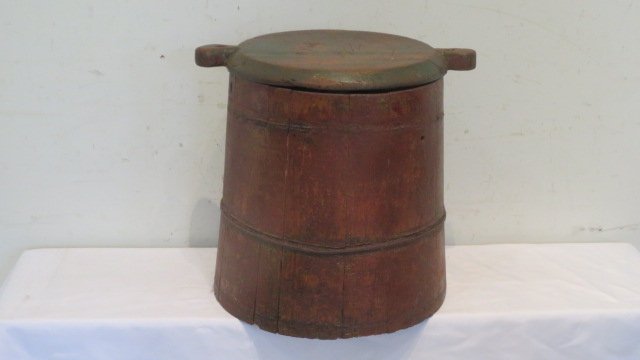 Late 19th century storage pail with wooden lid: Late 19th century storage pail with wooden lid, one wire band (2 missing), lid has traces of old green paint and bottom is in old red paint, 15"T x 16"W (to end of handles)