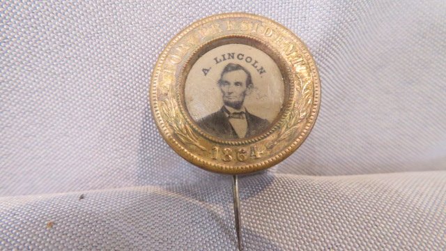 1864 Lincoln Ferrotype political pin: 1864 Lincoln Ferrotype political pin, 1 1/2"l. x 1" dia., Provenance, the Robert Tess Collection, Warsaw, Indiana