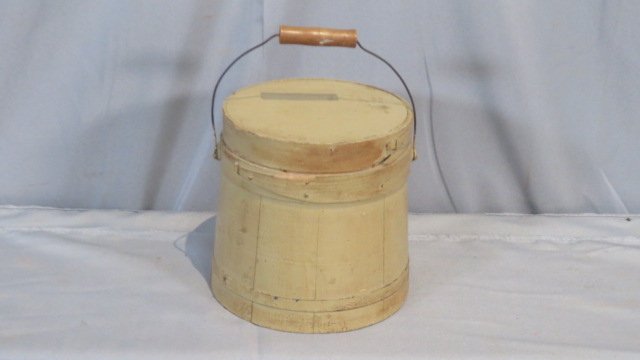 Wood firkin in mustard paint with lid: Wood firkin in mustard paint with lid, metal and wood bands, wire bale with wood handle, 6.5"T x 6.25"W (at top) & 6.75"W (at bottom)