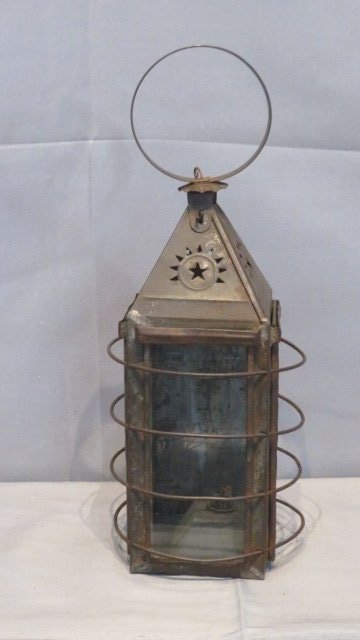 Early 19th century tin lantern with whale oil burner: Early 19th century tin lantern with whale oil burner, glass on 3 sides and sliding tin back door, punched stars and sunburst around top, 15.5"T x 6" square