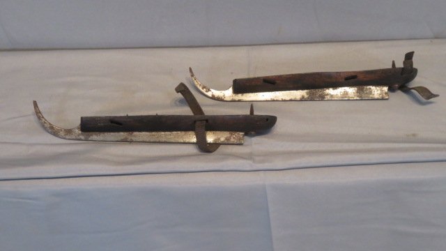 Pair of 19th century wood, brass, and steel ice skates: Pair of 19th century wood, brass, and steel ice skates with remnants of a leather strap, 13"L
