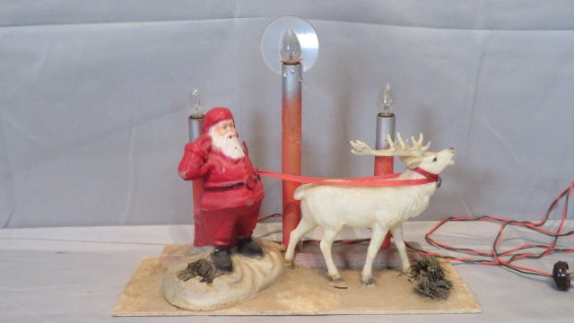 Santa and reindeer candelabra: Santa and reindeer candelabra, Santa is papier-mache, deer is celluloid, base is cardboard, original wiring, 12.5"T x 16"L x 5.75"D