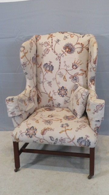 Mid 19th century wing chair with crewel type upholstery on wooden casters: Mid 19th century wing chair with crewel type upholstery on wooden casters, legs are walnut, purchased at Garth's in the Tom Porter era, 47"T x 34"W x 25"D