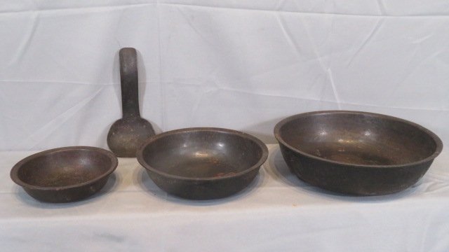 4 pcs of cast iron, bowls and ladle: 4 pcs of cast iron including a nest of 3 bowls and a ladle, largest bowl is 11.5"diam x 3"deep