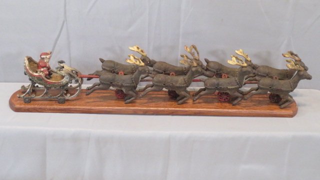 Mid-20th century cast iron Santa with sleigh and 8 reindeer on wheels (1 of 7)