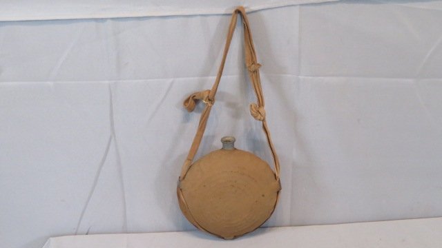 Civil War canvas covered metal bullseye canteen with a strap (1 of 5)