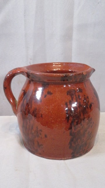19th century redware pitcher with orange glaze and black decoration (1 of 4)