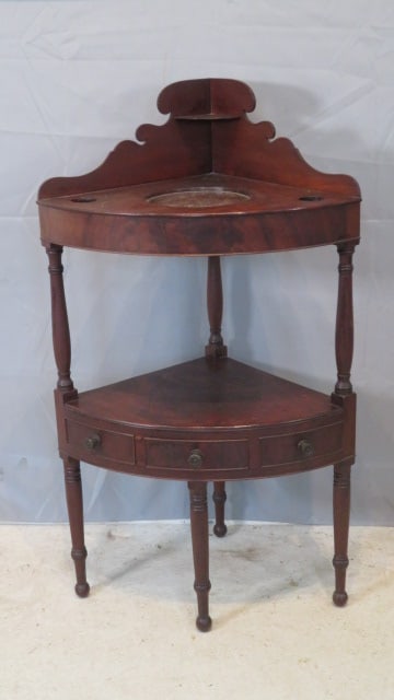 Mid-19th century cherry corner washstand: Mid-19th century cherry corner washstand with a dovetailed drawer (the other 2 drawer fronts are faux), original surface, dovetailed backsplash, 42"T x 24"W (at front) x 18"D, will fit a 17" corner