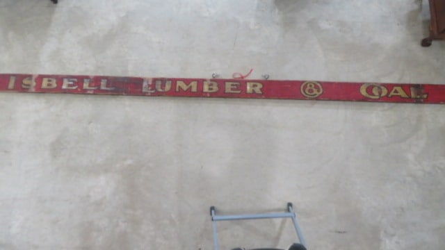 Wooden sign for Isbell Lumber & Coal Co.: Wooden sign for Isbell Lumber & Coal Co. with red background, gold letters with black outlines, supposedly from Elkhart, Indiana, 11 feet 8 inches long and 6" tall