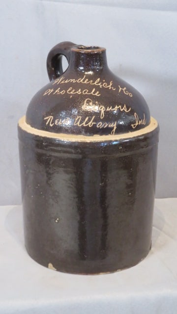 1-gal stoneware Albany glazed jug from New Albany, Ind: 1-gal stoneware Albany glazed jug from New Albany, Ind, marked in freehand "Wunderlich & Co Wholesale Liquors New Albany Ind", 11"T x 7"diam