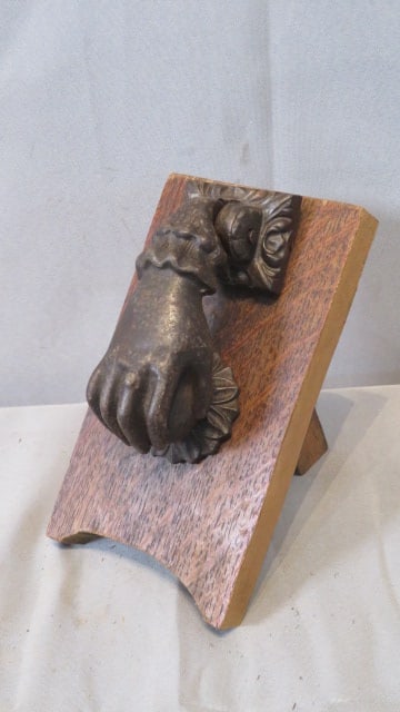 Cast iron door knocker in the shape of a hand (1 of 4)